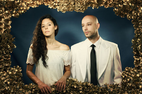 Members of the band mr. Gnome, including art eduction alumna Nicole Barille; image of a woman and man standing in a frame of gold leaves