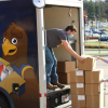 Volunteer students loading boxes of food into the Division of Philanthropy and Alumni Engagement mobile unit